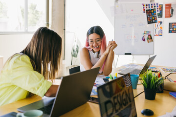 Creative team collaborating cheerfully in modern office space