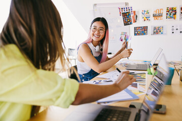 Creative collaboration between two young women in modern office
