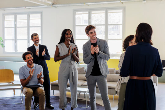 Enthusiastic business people applauding after a meeting in office