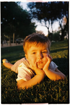 Boy resting on grass