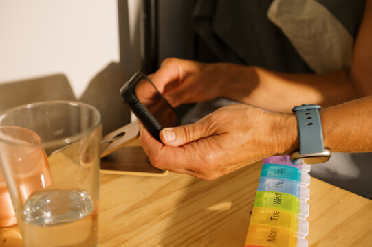 woman unplugging her phone on nightstand