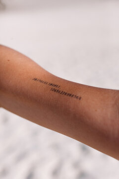 Crop person with tattoo with digits on arm