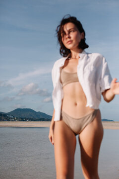 Slim woman in bikini on beach