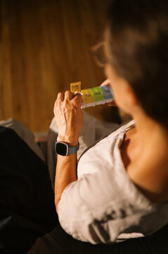 woman taking supplement pill at home in bedroom