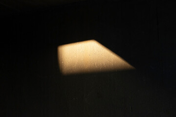 Wall with beam of light golden hour geometric light reflection 