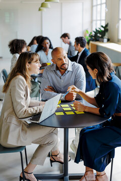 Business team brainstorming new ideas together at office
