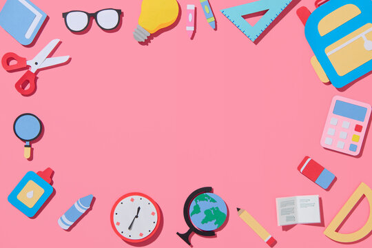 School elements on pink background with space for text
