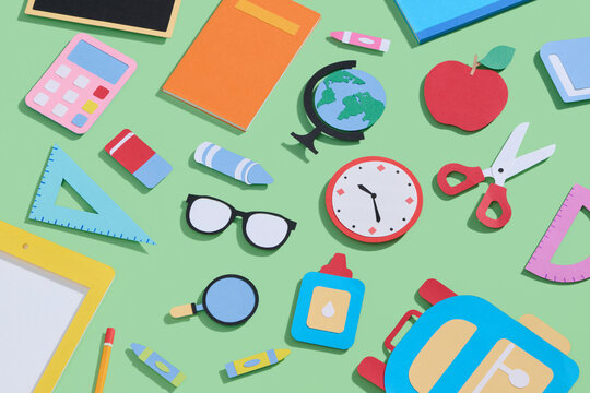 Paper cut school supplies set in polygonal trendy craft style.