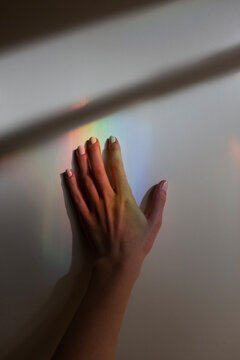 Hand with colorful multicolor spectrum rainbow reflection