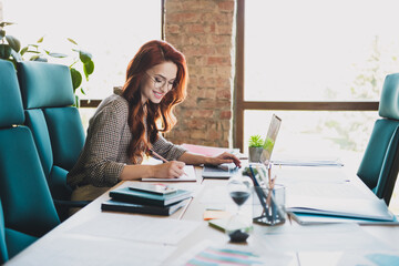 Photo of attractive good mood lady ceo dressed formal shirt smiling writing notes indoors workplace...