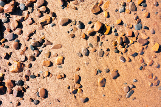 Pebbles on a sandy beach