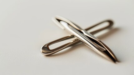 Cross-shaped arrangement of two sewing needles on a white background, highlighting needlework and craft. Must-have tools for stitching and embroidery, bringing a handmade feel to fabric design