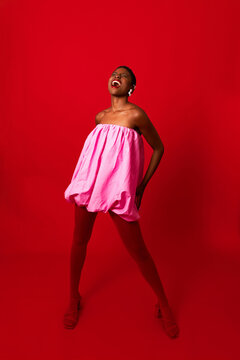 Giggling woman in pink dress