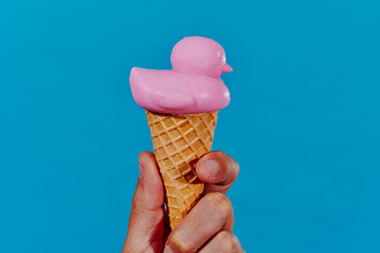 duck-shaped ice cream cone in the hand of a man