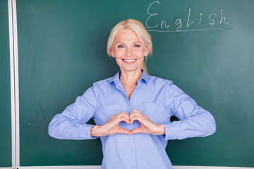 Photo of charming cheerful senior lady wear shirt university lecture isolated on green board background