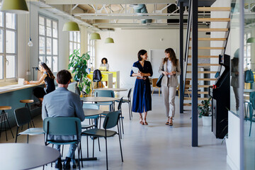 Managers walking and discussing in a modern coworking space