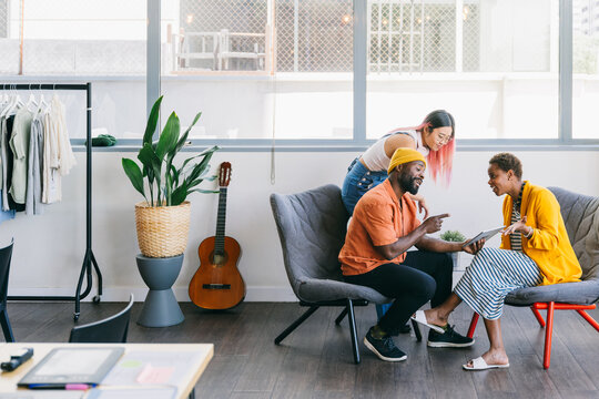 Casual collaborative meeting of diverse colleagues in modern office