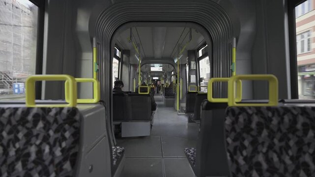 Berlin streetcar interior during the ride. Theme electric rail public transportation in Berlin, Germany. Interior view of Berlin streetcar, empty compartment. Strassenbahn in Berlin Innenaufnahme. 