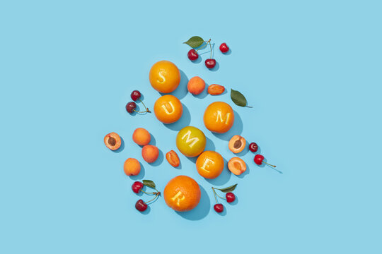 Ripe fruits scattered randomly and creating summer word
