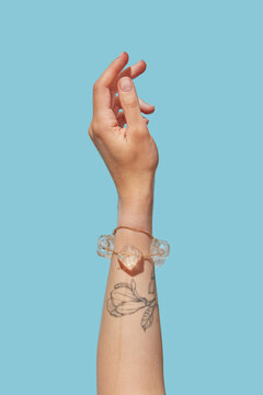 Hand of female presenting stylish jewellery with melting ice cubes