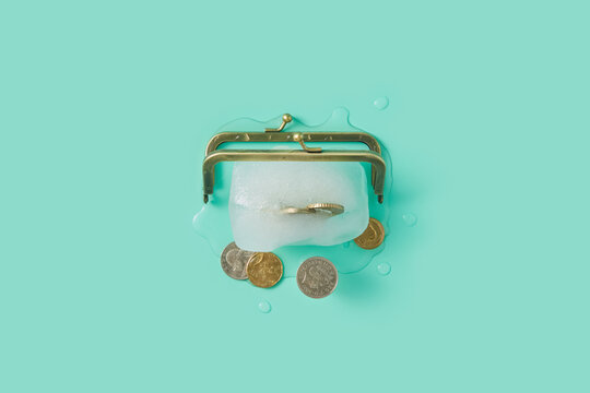 Ice dissolving in heat and freeing coins under opened lock of purse