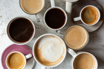 Overhead image of multiple mugs and cups of coffee