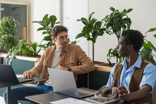 Colleagues Discussing Work In Office