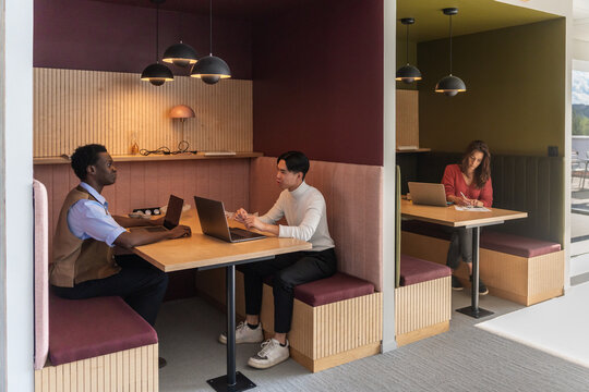 Colleagues Working in Office Booths


