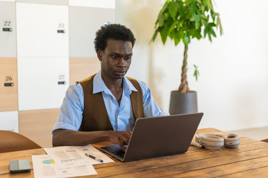Professional Black Businessman Focused On Laptop In Office