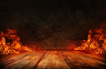 wooden table with Fire burning at the edge of the table, fire particles, sparks, and smoke in the...