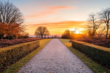 A garden path at sunset, with the sky painted in warm hues