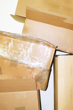 Stacked brown delivery cardboard boxes with hard direct flashlight