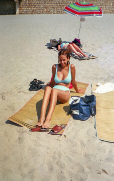 Analog image of a woman on the beach in Benidorm, Spain in the 90s