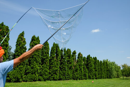 Kids animator making soap bubbles on the field
