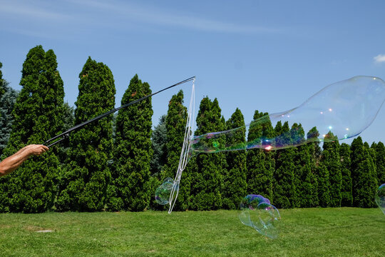 Kids animator making soap bubbles on the field