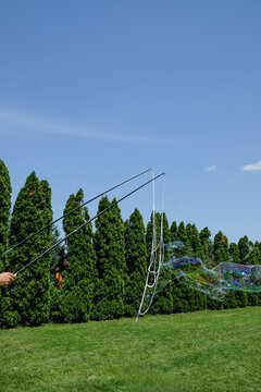 Kids animator making soap bubbles on the field