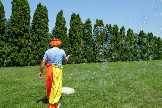 Kids animator making soap bubbles on the field