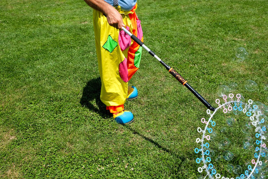 Kids animator making soap bubbles on the field