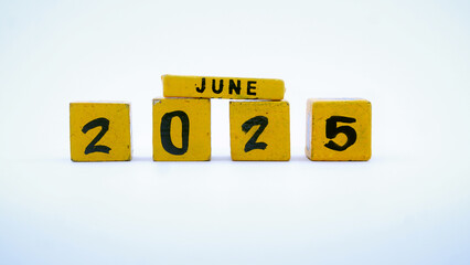 Wooden block calendar for June 2025. Yellow on a white background