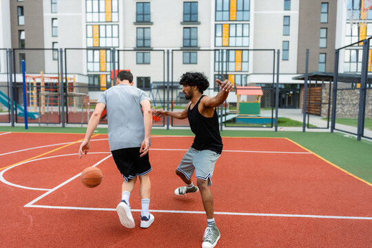 Men play basketball