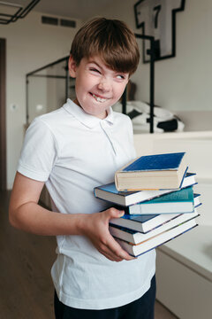 Funny Boy Holding Books Indoors