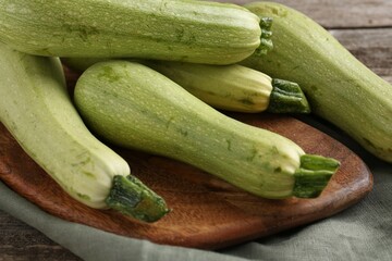Raw ripe green zucchinis on table, closeup