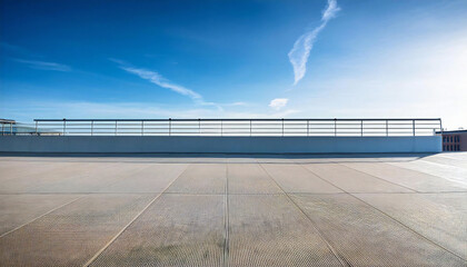 Fototapeta premium A sunny day on the roof of a school building. A rooftop view with concrete, railings and blue sky.