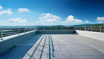 A sunny day on the roof of a school building. A rooftop view with concrete, railings and blue sky.