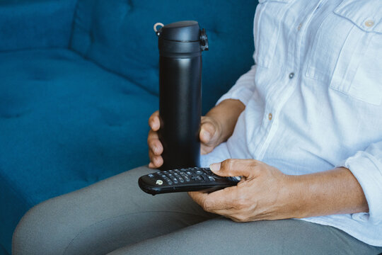 Senior  Woman's Hand Holding TV Remote Control