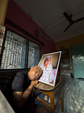 Indian man offering respect to his deceased father