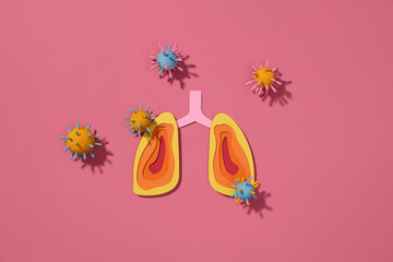 Colorful Paper Lungs with Virus Particles on red background