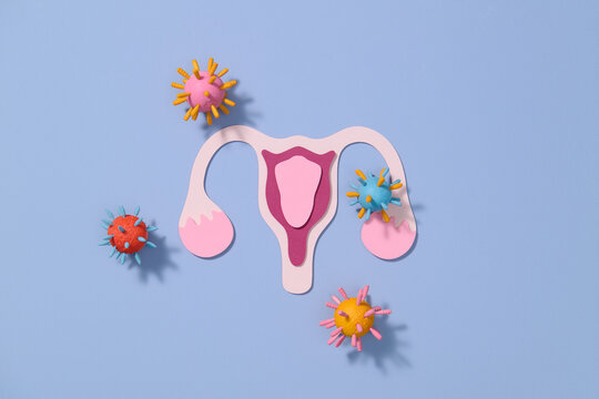 Uterus Model Surrounded by Virus and Bacteria on Blue Background