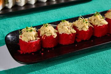 Gourmet Crab Rolls with Tobiko on Black Plate – Premium Sushi and Seafood Cuisine Photography