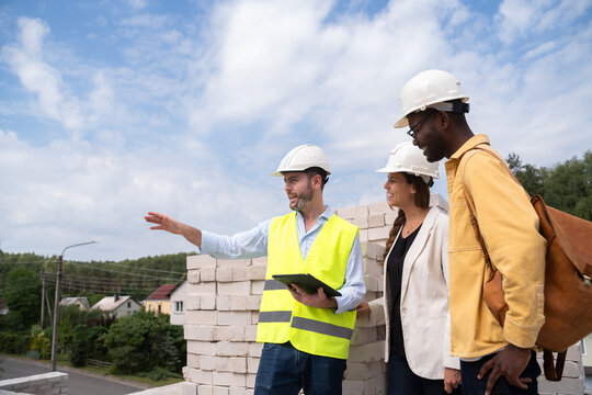 Architect Showing Construction Progress To Investors On Site